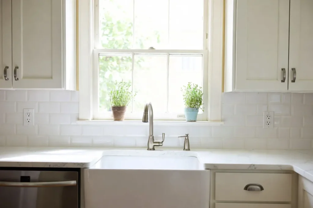 Bright modern kitchen with white peel-and-stick subway tile backsplash and white shaker cabinets