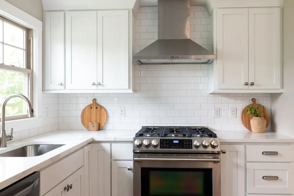 Modern kitchen with white peel and stick subway tile backsplash behind stainless steel range