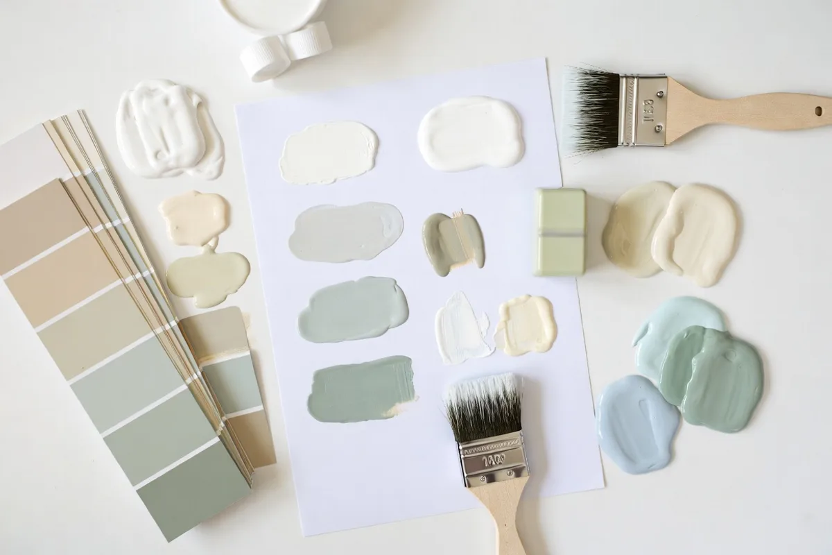 Paint color swatches and sample chips showing undertone differences for small living room color selection